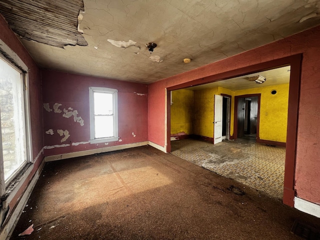 unfurnished room with visible vents and baseboards