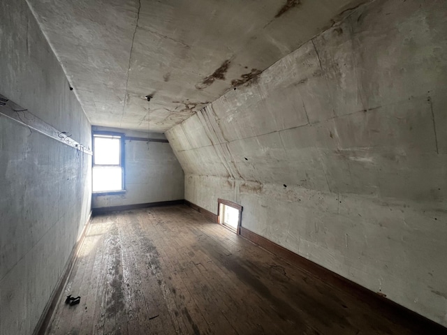 additional living space featuring lofted ceiling and hardwood / wood-style flooring