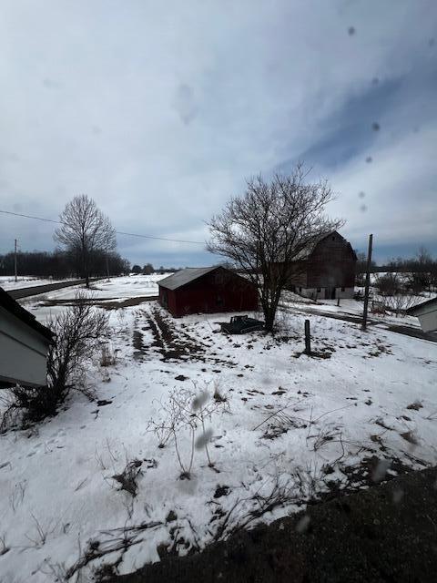 yard covered in snow with a garage