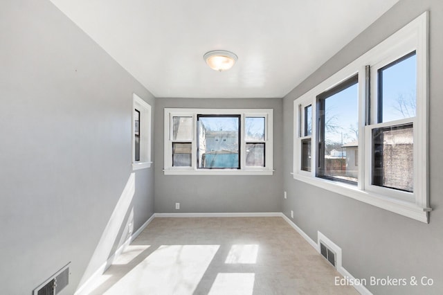 empty room with visible vents and baseboards