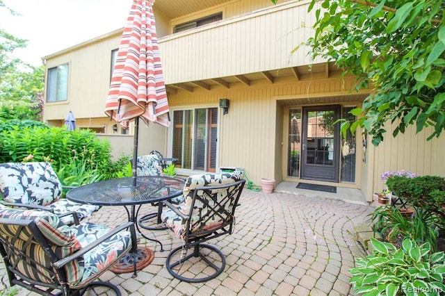 view of patio featuring outdoor dining space and a balcony