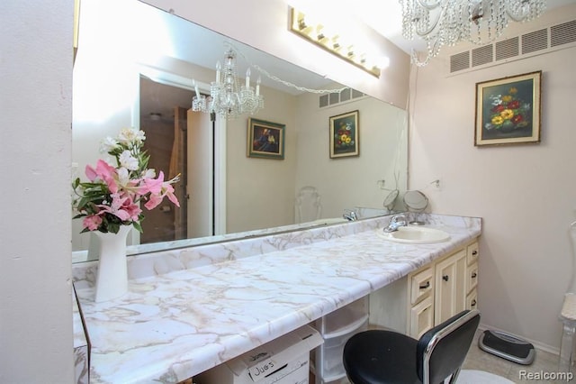 bathroom with vanity, visible vents, and baseboards