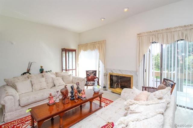 living area with a healthy amount of sunlight, recessed lighting, and a high end fireplace