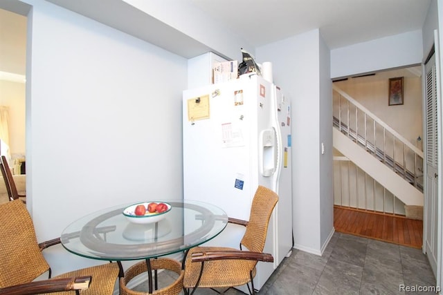 dining space featuring stairway