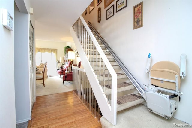 stairs featuring wood finished floors