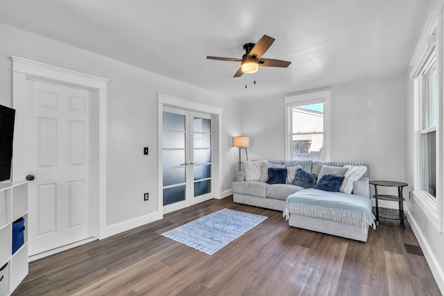 living area featuring french doors, visible vents, dark wood-type flooring, a ceiling fan, and baseboards