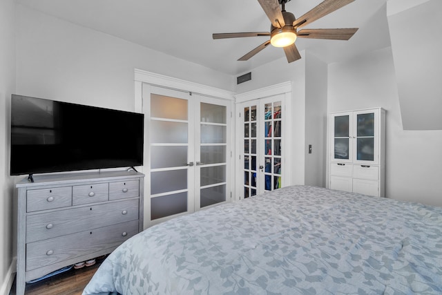 bedroom with french doors, ceiling fan, and dark wood-style flooring