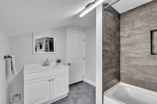 full bathroom with baseboards, visible vents, lofted ceiling, shower / bathtub combination, and vanity