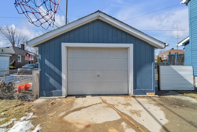 detached garage with driveway and fence