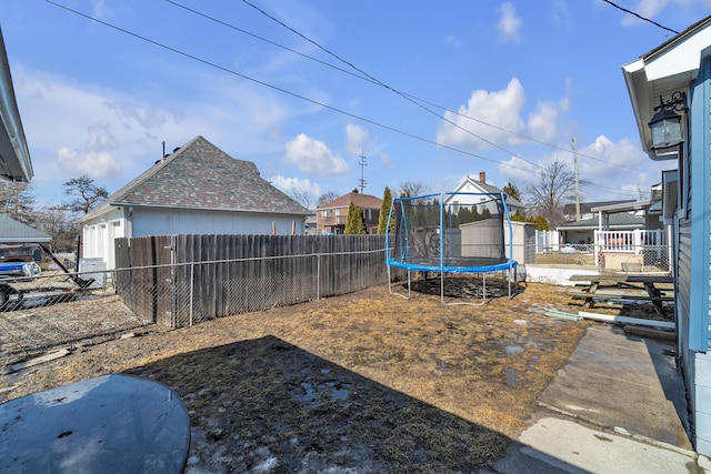 view of yard featuring a fenced backyard and a trampoline