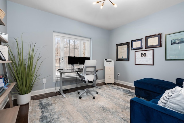 office space with baseboards and wood finished floors