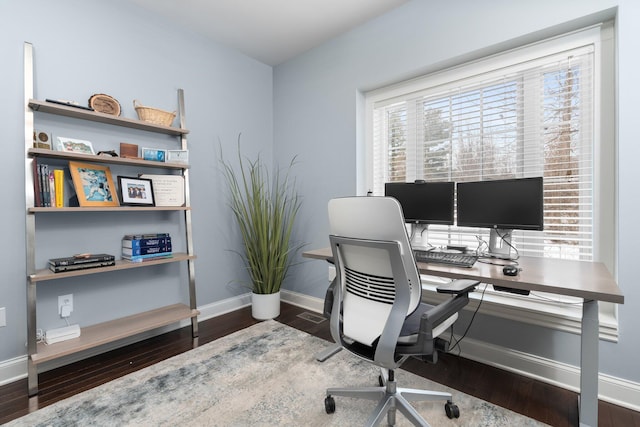 office area featuring dark wood-type flooring and baseboards