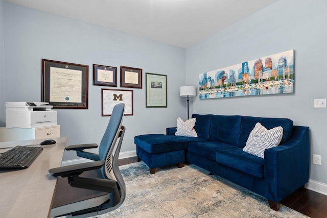 home office with baseboards and wood finished floors