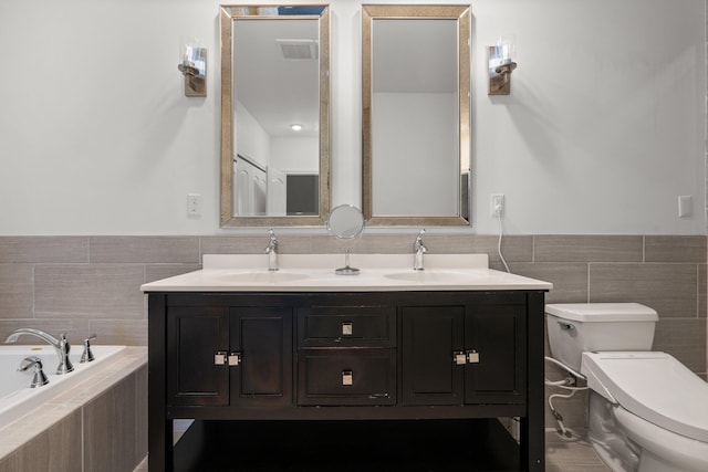 full bathroom featuring toilet, a garden tub, double vanity, and a sink