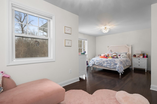 bedroom featuring dark wood-type flooring and baseboards