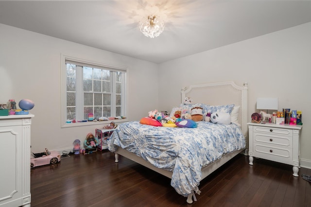 bedroom with dark wood-style flooring