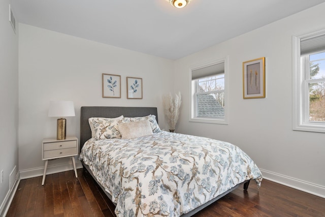 bedroom featuring dark wood-type flooring, visible vents, and baseboards