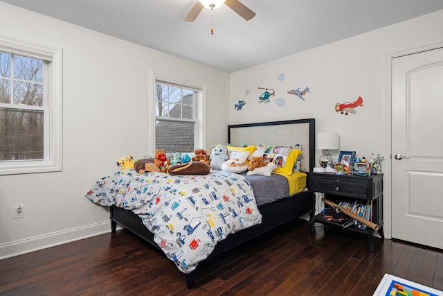 bedroom featuring ceiling fan, baseboards, and dark wood-style flooring