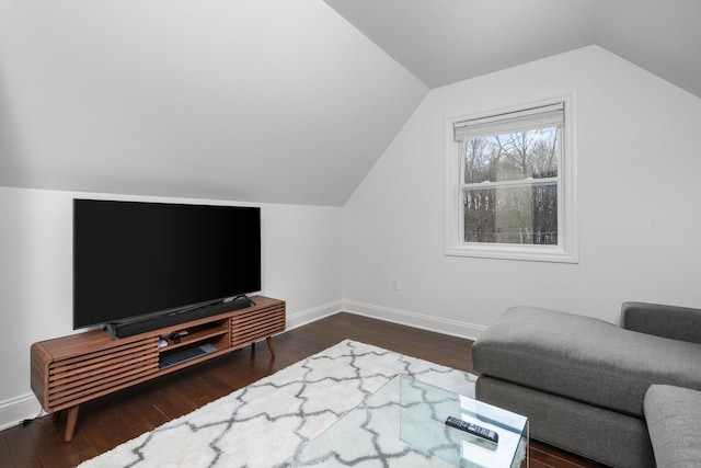 living area featuring lofted ceiling, dark wood-style flooring, and baseboards