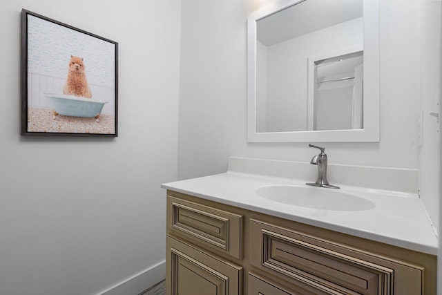 bathroom with vanity and baseboards