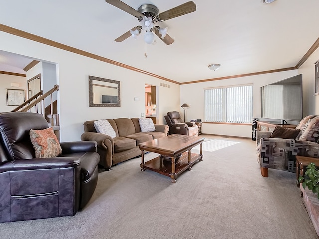 living area featuring crown molding, light colored carpet, visible vents, a ceiling fan, and stairs