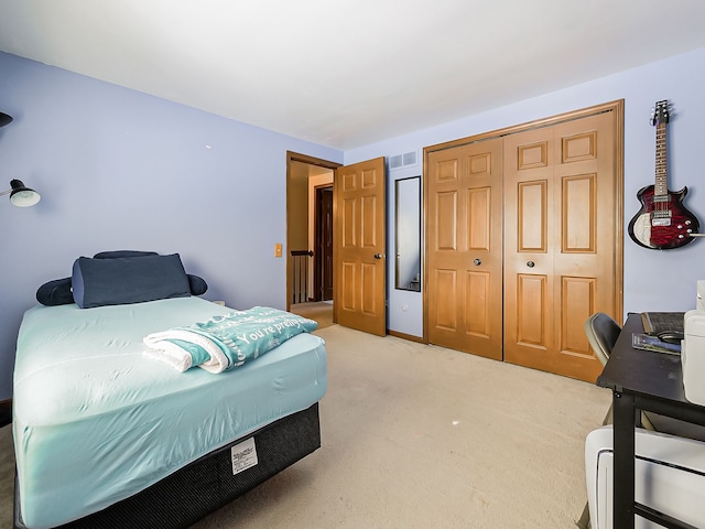 carpeted bedroom with a closet and visible vents