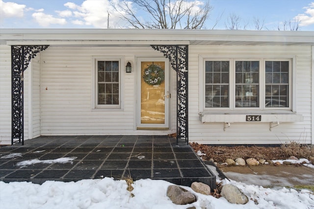 view of snow covered property entrance