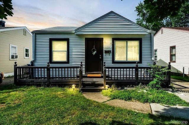 bungalow-style home with a lawn