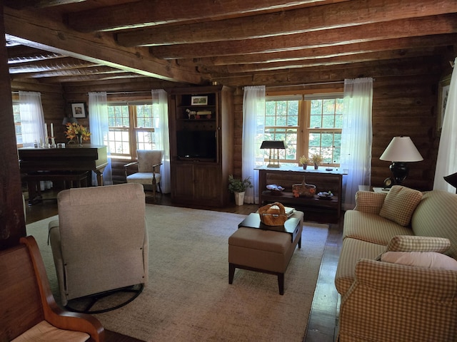 living area featuring log walls and beamed ceiling