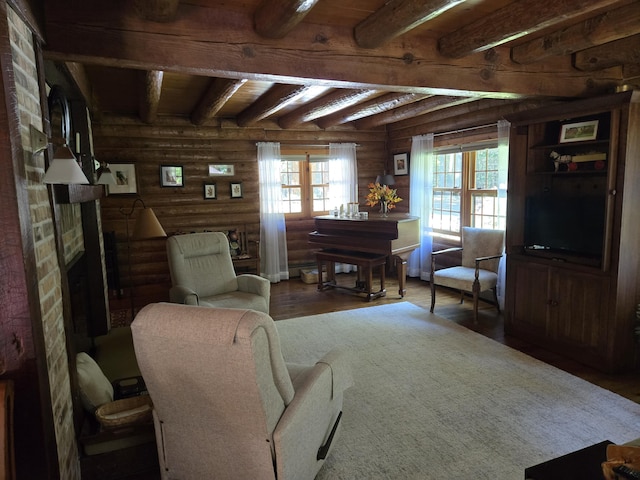 living area with a fireplace, log walls, wood finished floors, and beamed ceiling