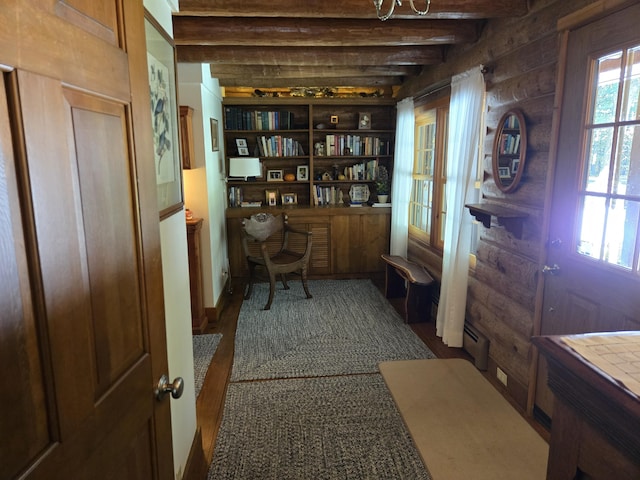 office space with a baseboard radiator, rustic walls, and beamed ceiling