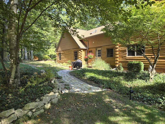 view of property exterior with log siding