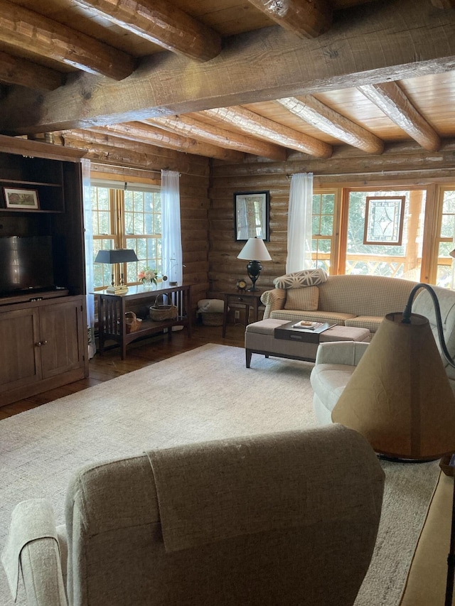 living area with beam ceiling, rustic walls, wood finished floors, and wood ceiling