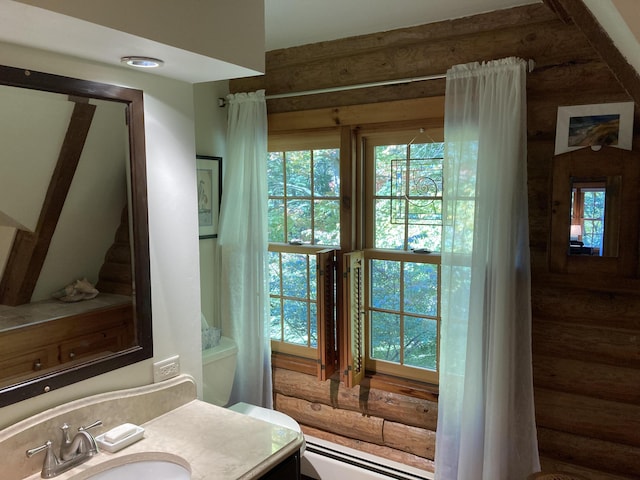 bathroom featuring a baseboard heating unit, plenty of natural light, and vanity