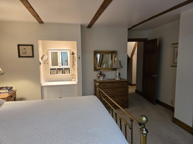 carpeted bedroom featuring beam ceiling and baseboards