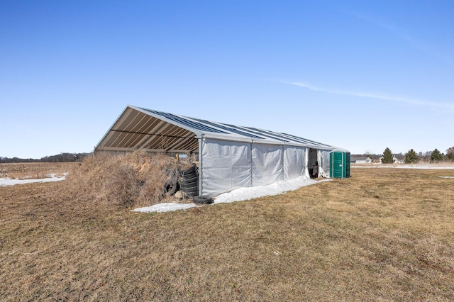 view of outbuilding featuring a rural view and an outdoor structure