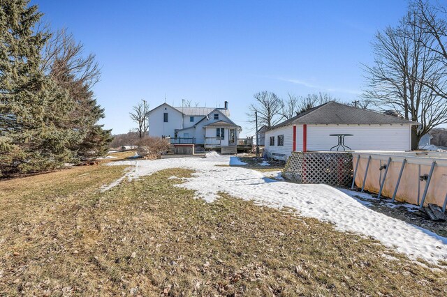 rear view of house with a lawn and a wooden deck