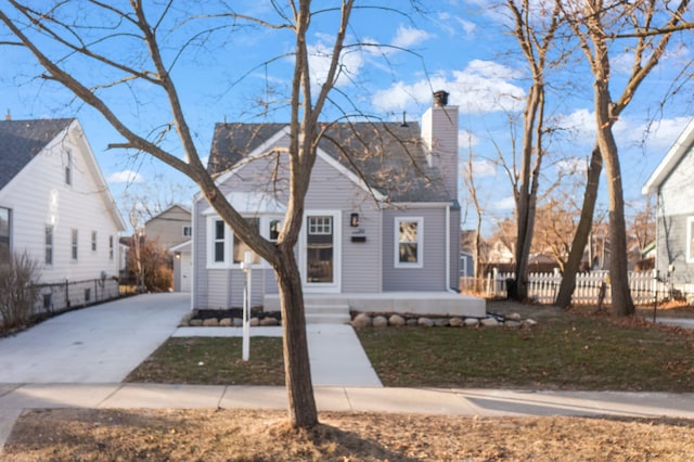 view of front of house featuring a chimney and fence