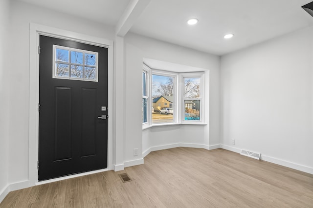 entrance foyer with light wood finished floors, recessed lighting, visible vents, and baseboards