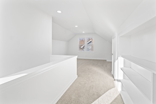 corridor with light carpet, recessed lighting, baseboards, and lofted ceiling