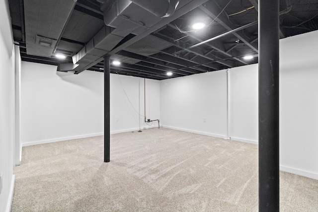 finished basement featuring baseboards and carpet flooring