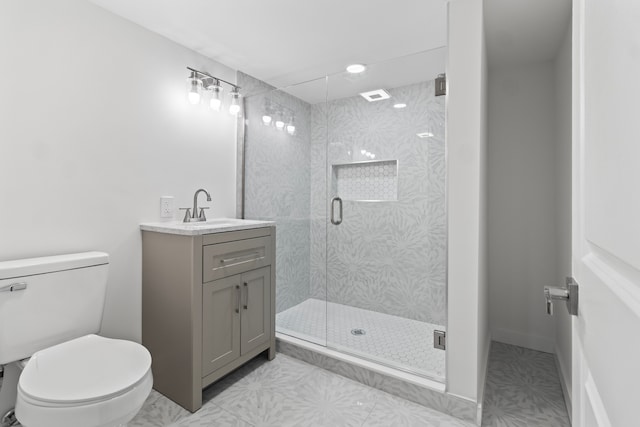 full bathroom featuring a stall shower, vanity, and toilet