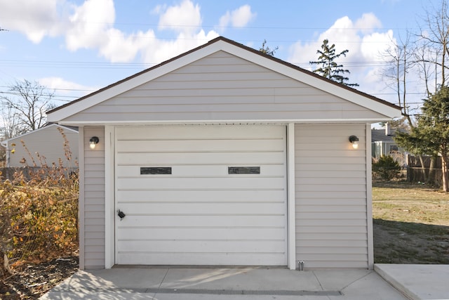 detached garage featuring fence