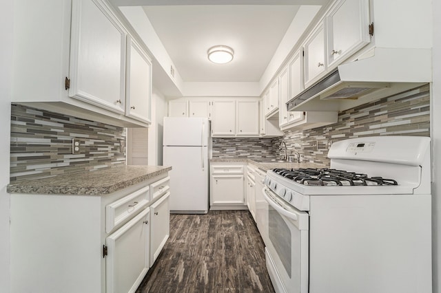 kitchen with white appliances, white cabinets, decorative backsplash, dark wood-type flooring, and a sink