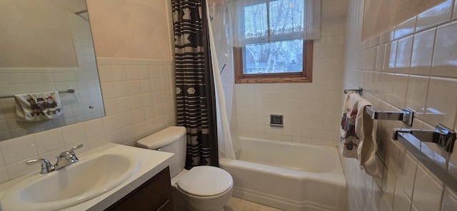 bathroom with toilet, vanity, tile walls, and shower / bathtub combination with curtain