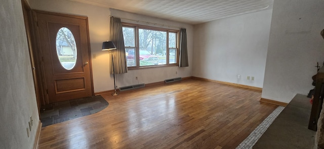 entryway featuring wood-type flooring, visible vents, and baseboards