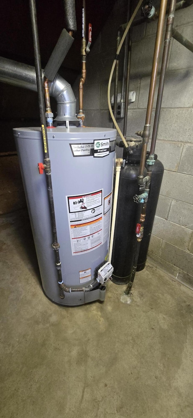 utility room featuring gas water heater