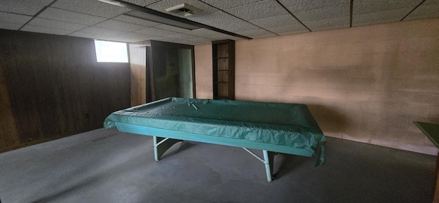 game room featuring a paneled ceiling, concrete flooring, and pool table