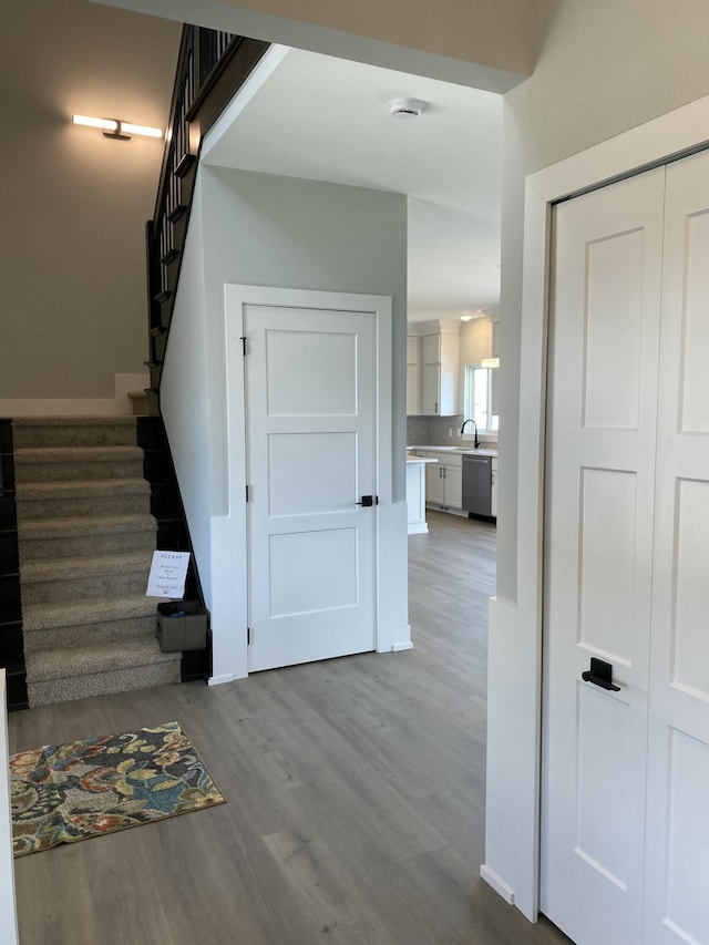 stairway featuring wood finished floors