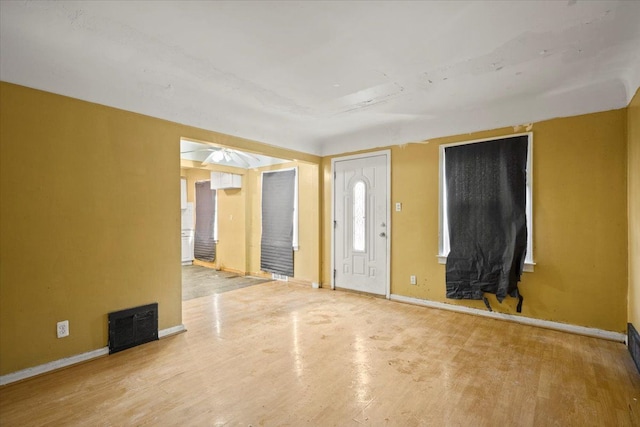 entryway with visible vents, baseboards, and wood finished floors